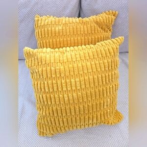 Two acent pillows with 2 yellow covers 17"x17"